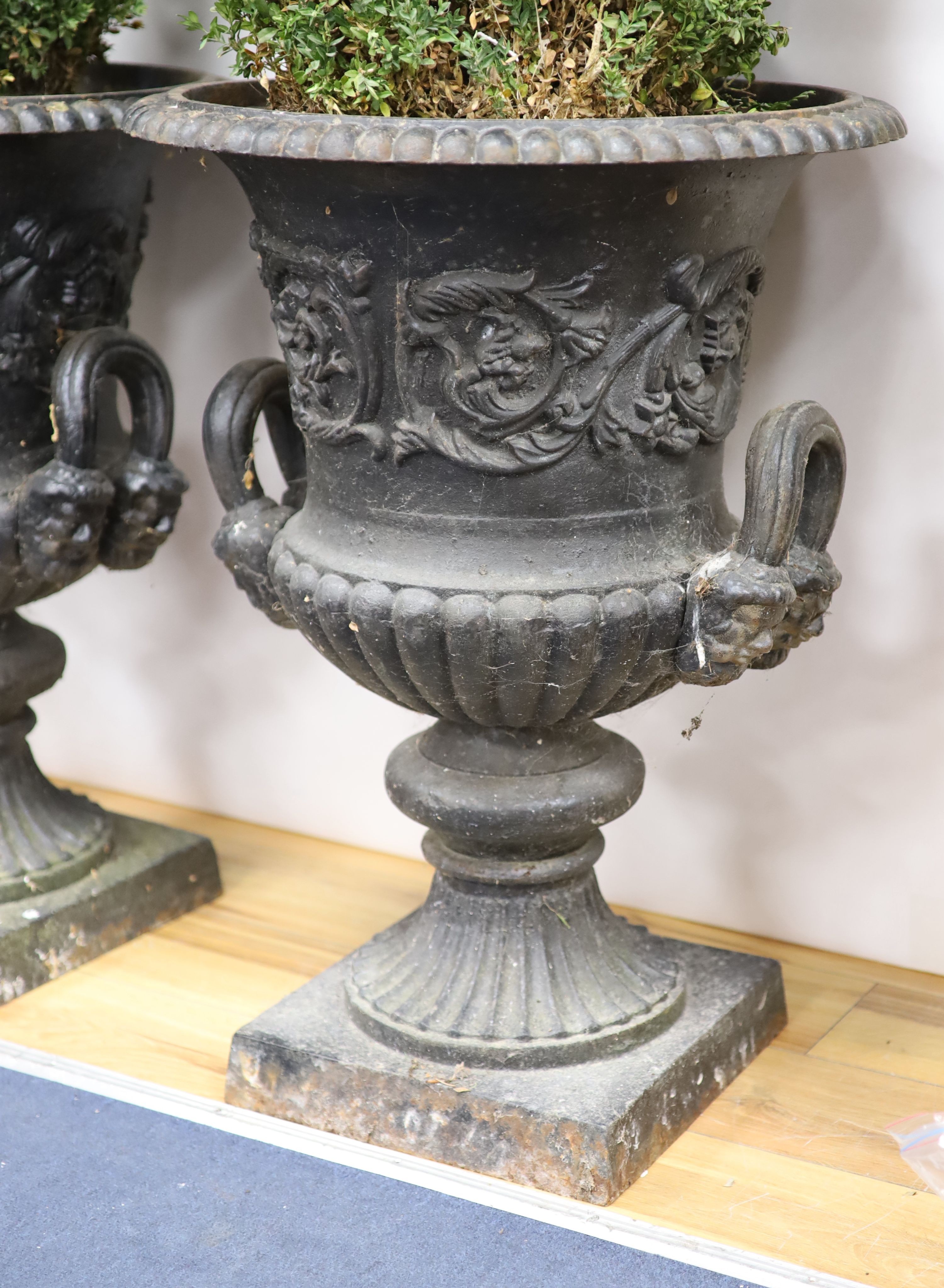 A pair of Victorian cast iron campana garden urns H 77cm. D 56cm.
